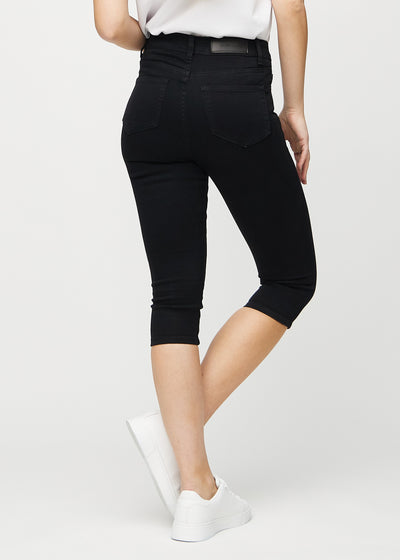 Sorte skinny capris set bagfra, så man kan se hele produktet.