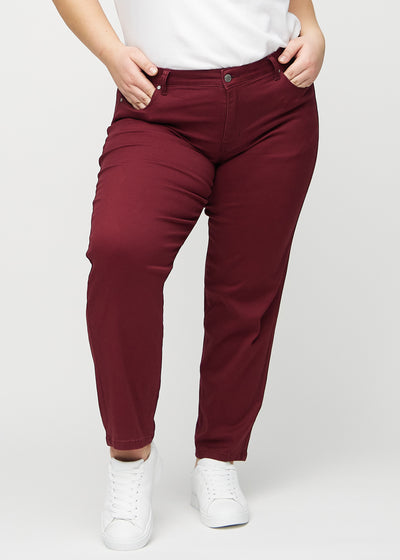 Mørkerøde regular jeans, modelnavn Santas, som går lige ned langs benet på en plus-size model, set forfra.